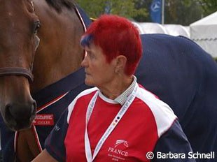 A French groom walking a horse