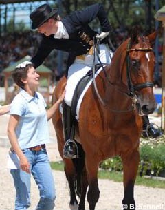 Isabell Werth gives groom Anna Kleniuk a pat while leaving the ring with Satchmo as 2007 Aachen Grand Champions :: Photo © Barbara Schnell