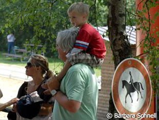 No riding here, says the sign, except on your father's shoulder. Nora Knutsen's family waiting for the score