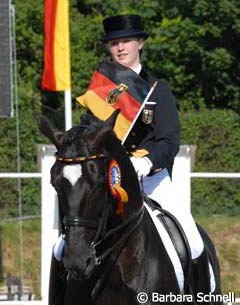 The gold medal winning Jill de Ridder and Disco Boy ride their lap of honour