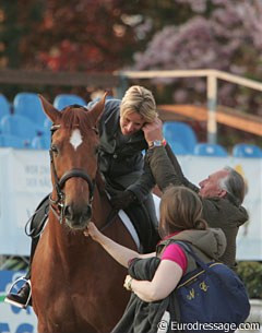 Klaus Balkenhol helps Nadine Capellmann to fit the earpiece