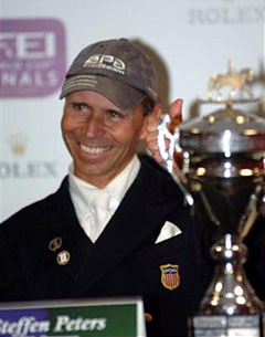 Steffen Peters all smiles with his World Cup Trophy in front of him