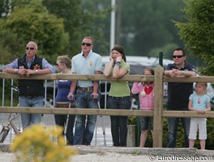 Charlotte Gill's trainer Darryl Thickitt in crutches. The fans watch Charlotte ride.