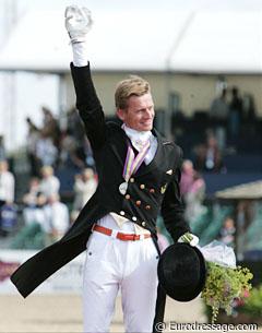 Edward Gal waves with a crystal trophy to the crowds