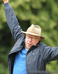 Danish trainer Bjarne Nielsen joking around: pretending he's falling off a fence