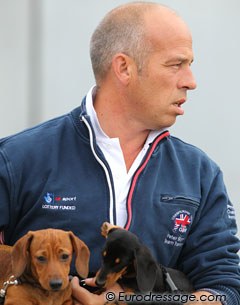 British pony team trainer Peter Storr with his two dachshund puppies