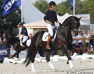 Boschman on Avatar, Carl Hester cooling down a horse in the background