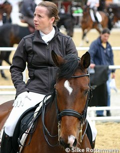 Isabell Werth and El Santo NRW in the warm up ring. Werth having a chat