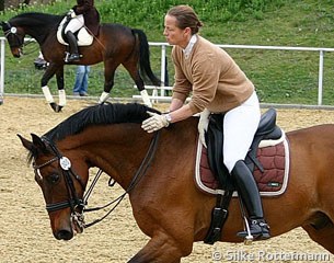 Isabell Werth gives Satchmo a big pat during their training session