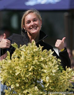 Belgian junior rider Noemie Goris lends a hand and picks up the protocols at the judges' boxes during the FEI Pony Team Test