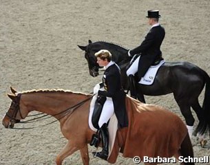 Ulla Salzgeber warming up Herzruf's Erbe, Hubertus Schmidt on Dark Diamond