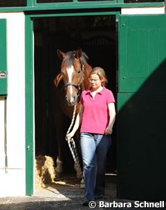 Groom Sabine Domhöver leads Girasol out of her stall