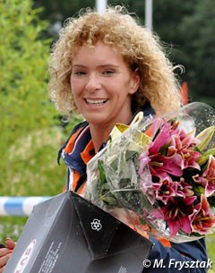 Dana's mom Nicolette is all smiles with her daughter's trophy and flowers in hand