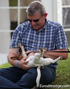 Belgian young rider Saidja Brison's father Philip plays with their dog