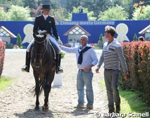Italian Silvia Rizzo leaves the ring on Donnerbube II while talking to Michele Betti and Carl Hester