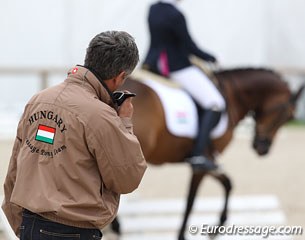 Hungarian pony team trainer Peter Pachl helping Esther Neel prepare her pony Antares
