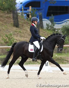 Maisie Scruton and Rembrandt. The pair does fantastic canter movements but in trot the black stallion hollows the back and he could be more consistent in the contact