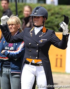 Van Lierop raises her fists when she sees her winning score flash on the board