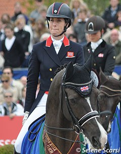 An emotional Charlotte Dujardin bites her lips while the British national anthem is playing to honour her world record scoring victory in the Grand Prix Special at the 2012 CDI Hagen :: Photo © Selene Scarsi