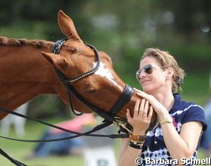 Patricia Koschel cuddling Companero, the horse of Maria Kalldewei, one of Christoph's students who got her golden rider's badge in Hagen