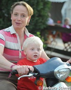 Isabell Werth with her son Frederik on the scooter