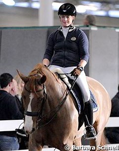 A helmet wearing Isabell Werth on Bella Rose