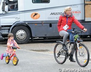 Ingrid Klimke on her bike with Philippa on her side