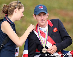 Bronze medalist Scott Brash gets a helping hand