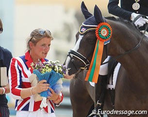 Holstein's Derwisch is interested in the bouquet British chef d'equipe Liz Mills got during the award ceremony