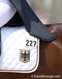 Vivien Niemann pins her tails to the saddle pad and removes the pins while leaving the ring after her test. Some people wondered what she was actually fidgeting about. Now you know! 