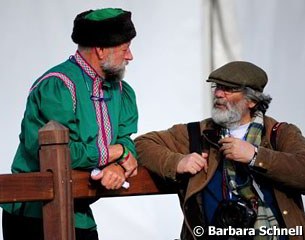 Renowned photographer Jacques Toffi talks to the ring steward who is dressed in a Russian outfit for the occasion