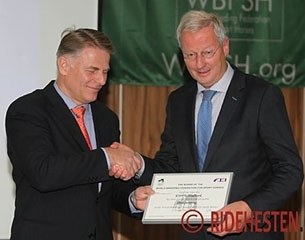 WBFSH President Jan Pedersen hands the winner's certificate to KWPN president Siem Korver at the 2013 WBFSH General Assembly :: Photo © Ridehesten