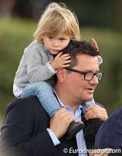 François Kasselmann carrying his child around the Verden show grounds