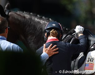 Caroline Roffman gets a supportive pat on the back from team trainer Robert Dover