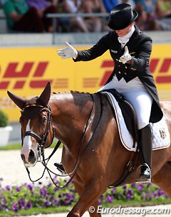 Isabell Werth points at her horse Bella Rose for her greatness