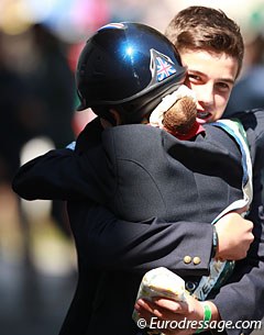 Phoebe Peters gives British eventing rider Oliver Williams a big a hug. Williams won team silver