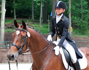 A smiling Laura Graves leaves the arena at the 2014 U.S. Dressage Championships in Gladstone