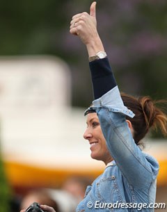 Lyndal Oatley signals to her husband Patrik in the warm-up that he has won the class