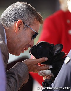 US team trainer Robert Dover snuggles with Evi Strasser's Hungarian bred French bull dog pup Maximilian