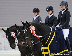 Juniors Kristina Shvetsova, Anna Aristova, Anna Ratsun in the prize giving ceremony at the 2014 CDI-JYR Ryazan in Russia :: Photo © Selene Scarsi