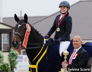 Peter Storr hands the trophy to Kristina Shvetsova, the junior rider individual test winner at the 2014 CDI-JYR Ryazan in Russia