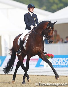 Ingrid Klimke and Franziskus showing proper bending the half pass at the 2014 World Young Horse Championships :: Photo © Astrid Appels