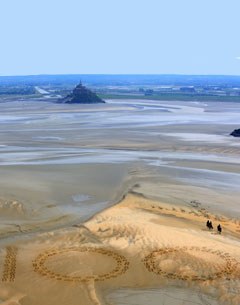 Giant 2.3m by 2.5m horse hoof prints created in the Bay of Mont-Saint-Michel, the famous UNESCO World Heritage Site, by French artist and sand sculptor Christophe Dumont, mark 100 days to the start of the 2014 World Equestrian Games