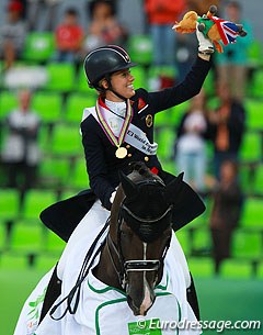 Charlotte Dujardin and Valegro in their victory lap. Charlotte is waving the British team's lucky mascot "Freddy" to the crowds. 