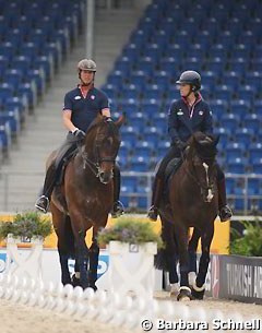 Carl Hester and his student Charlotte Dujardin hacking their horses in the main stadium