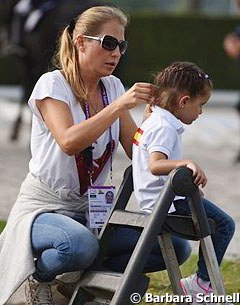 Braiding the hair of a very young Spanish fan