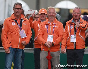 Dutch team trainer Wim Ernes and KNHS technical director Maarten van der Heijden have big smiles on their faces while Alex van Silfhout gives his son a thumb's up