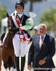 Anna Guseynova flanked by the judge at C, Juan Carlos Campos, at the 2016 European Children Championship