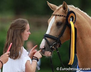 Pony rider now junior Nadine Krause owns the two top performing German ponies Danilo and Cyrill. Here she is cuddling with Danilo