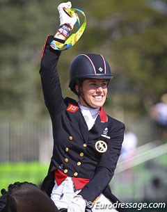Charlotte Dujardin waving her gold medal